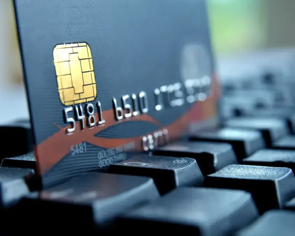 Zbliżenie na kartę płatniczą z numerem 5481 6510. Czy to bank 1750? Karta leży na klawiaturze.